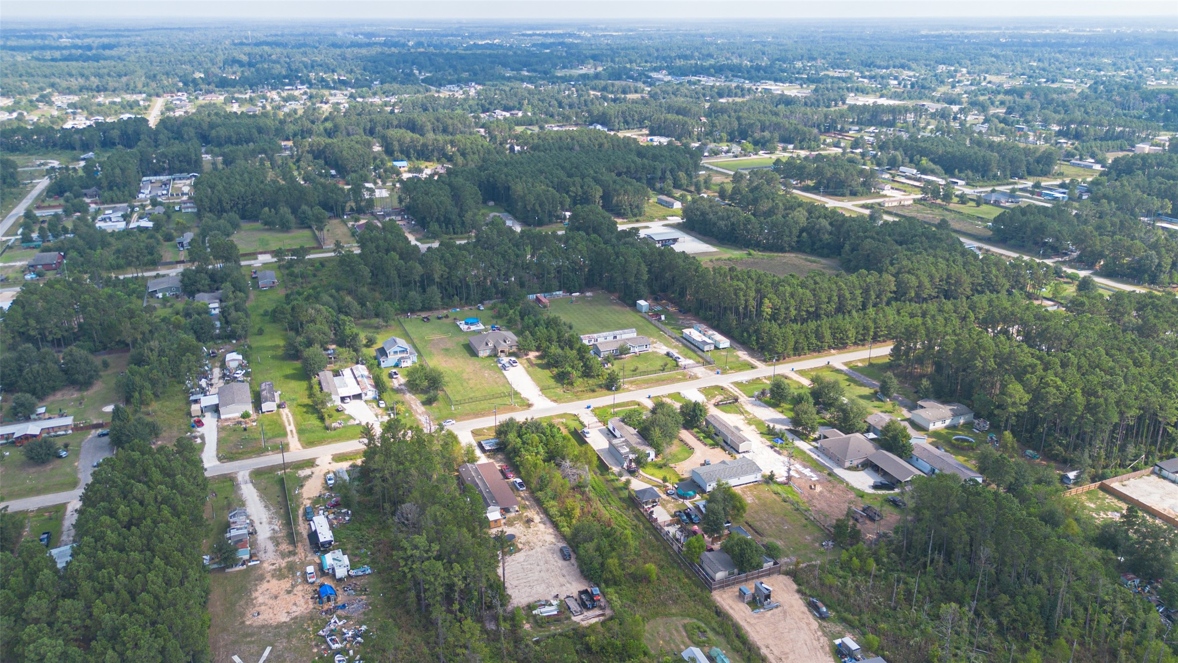 128 County Road 3548 Cleveland, TX 77327 - Photo 9 of 14 an aerial view of residential houses with outdoor space