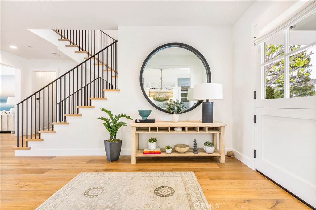 625 St James Road Newport Beach, CA 92663 - Photo 2 of 47 a view of a hallway with entryway wooden floor and front door