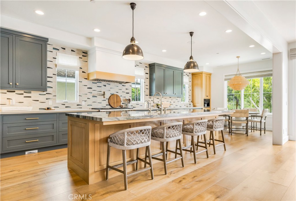 625 St James Road Newport Beach, CA 92663 - Photo 10 of 47 a kitchen with stainless steel appliances granite countertop a sink a stove and a wooden floors