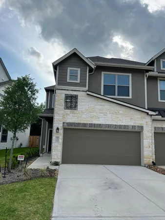 a front view of a house with yard and parking