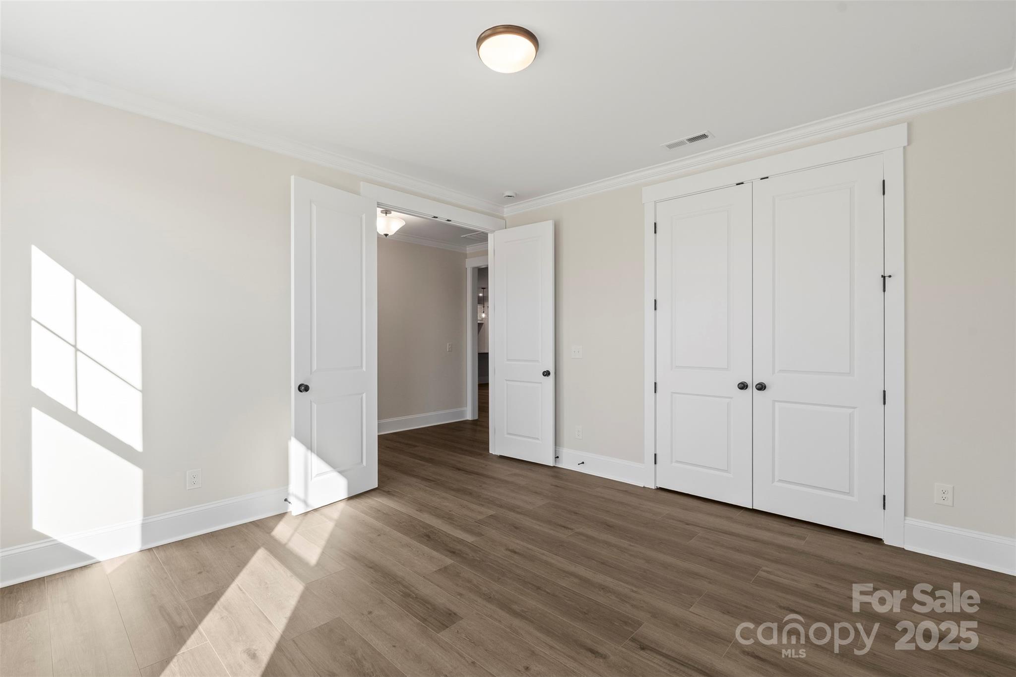 648 Digby Road, Unit 492 Rock Hill, SC 29730 - Photo 14 of 47 a view of an empty room with wooden floor and a window