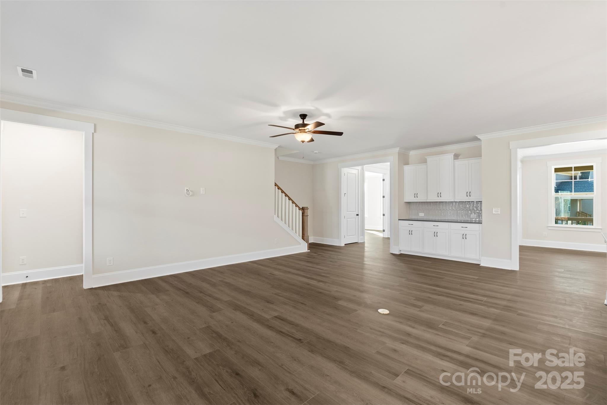 648 Digby Road, Unit 492 Rock Hill, SC 29730 - Photo 17 of 47 a view of an empty room with wooden floor and a kitchen