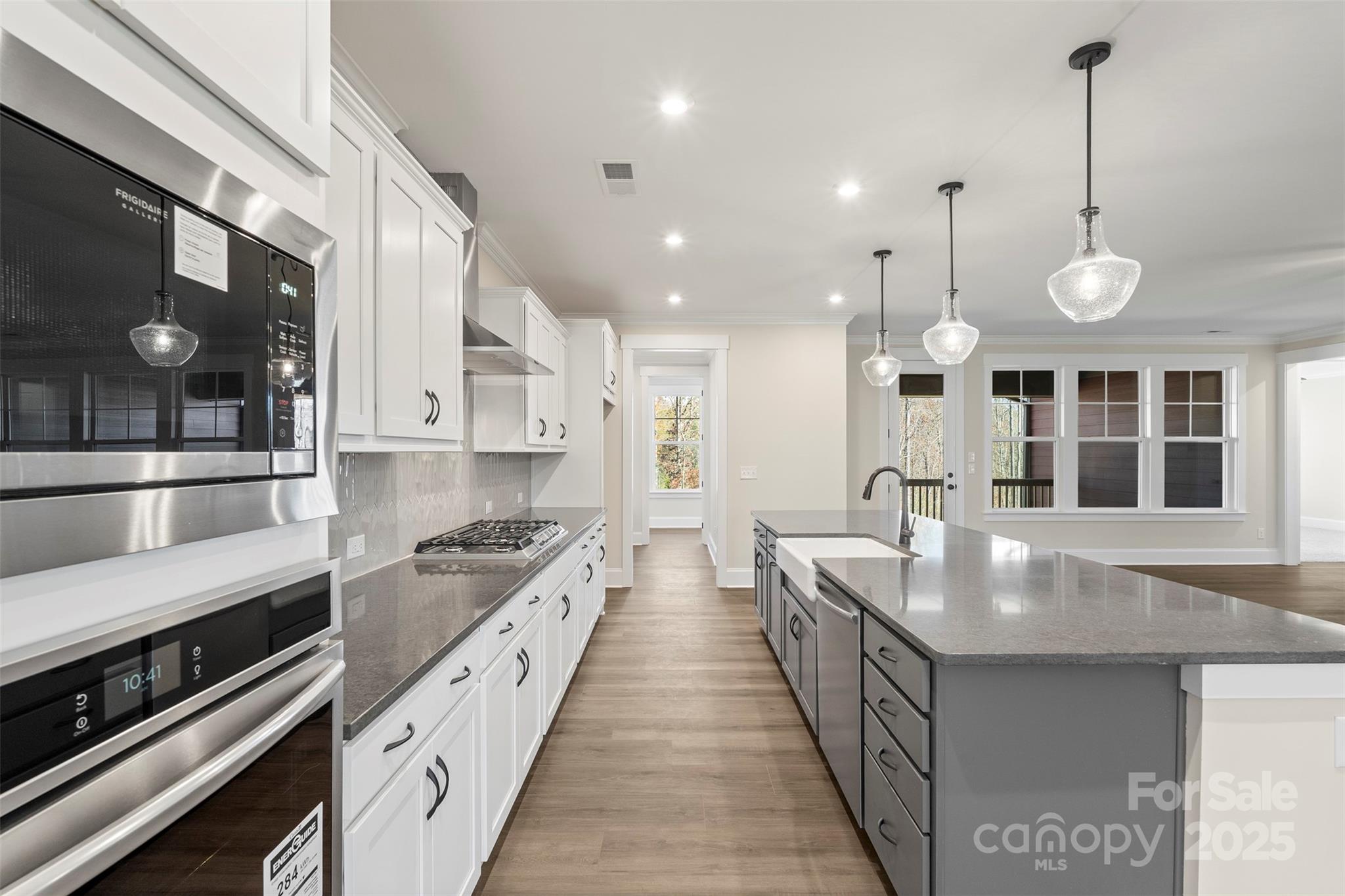 648 Digby Road, Unit 492 Rock Hill, SC 29730 - Photo 20 of 47 a large kitchen with kitchen island a stove a sink a counter top space and cabinets