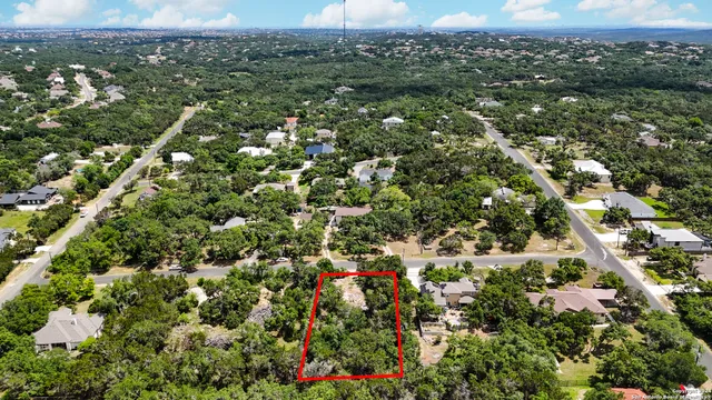 an aerial view of a houses with a yard