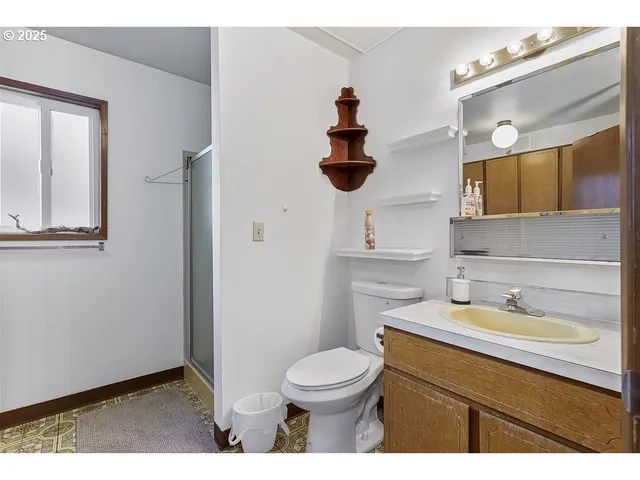 a bathroom with a sink a toilet and mirror