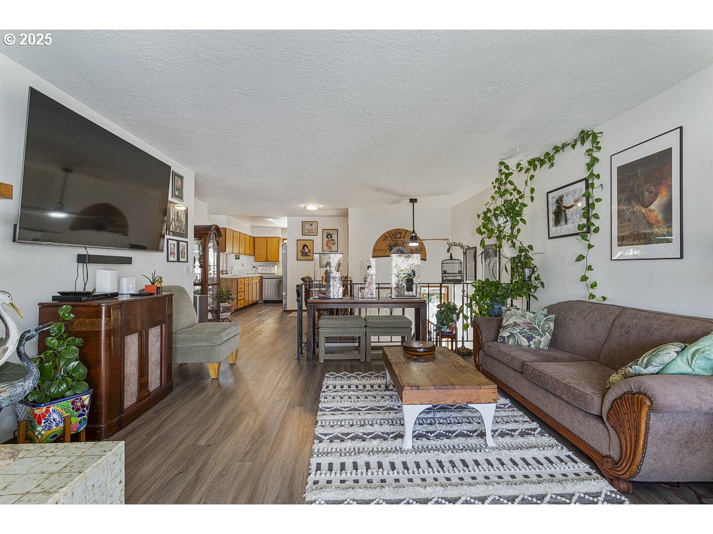 14850 Northeast Rose Parkway, Unit 67A Portland, OR 97230 - Photo 6 of 33 a living room with furniture and a flat screen tv