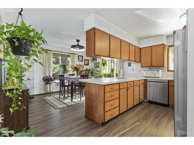 a kitchen with sink cabinets and wooden floor