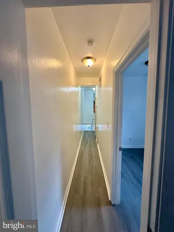 a view of gallery with wooden floor