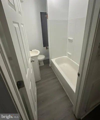 a bathroom with a sink a toilet a tub and a shower