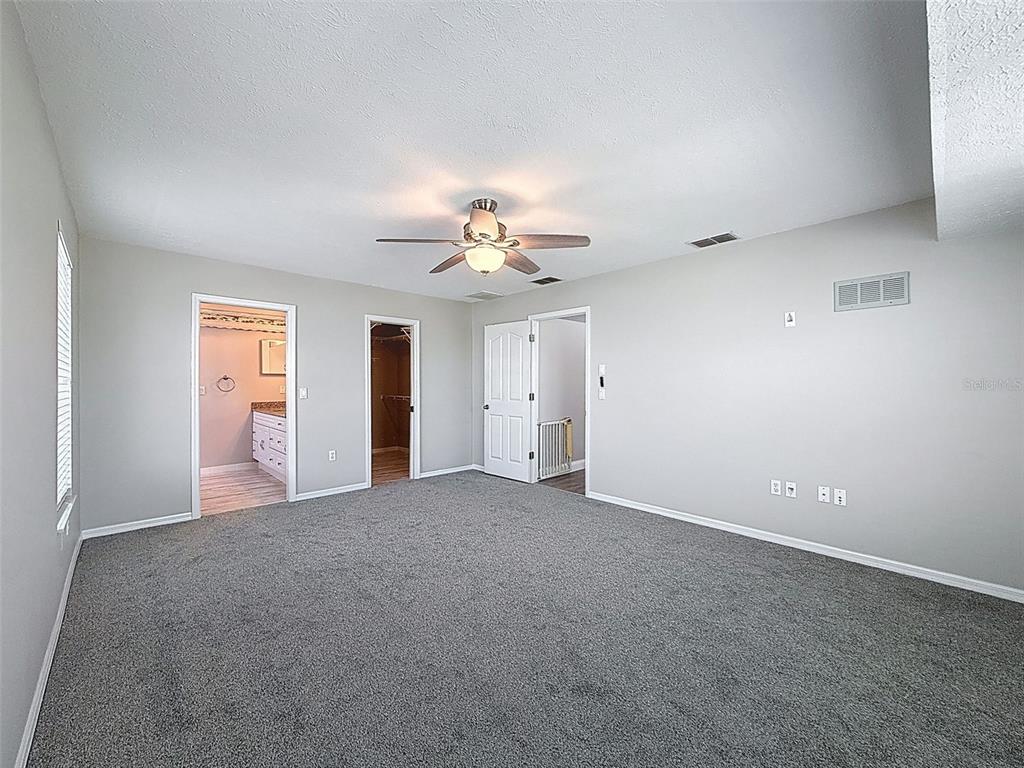 3342 Turks Cap Drive Hernando Beach, FL 34607 - Photo 54 of 100 a view of a big room with windows and chandelier fan