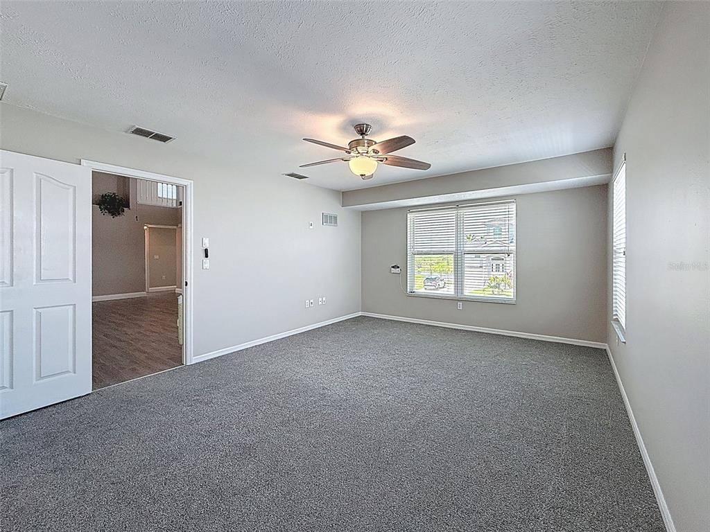 3342 Turks Cap Drive Hernando Beach, FL 34607 - Photo 56 of 100 an empty room with windows and ceiling fan