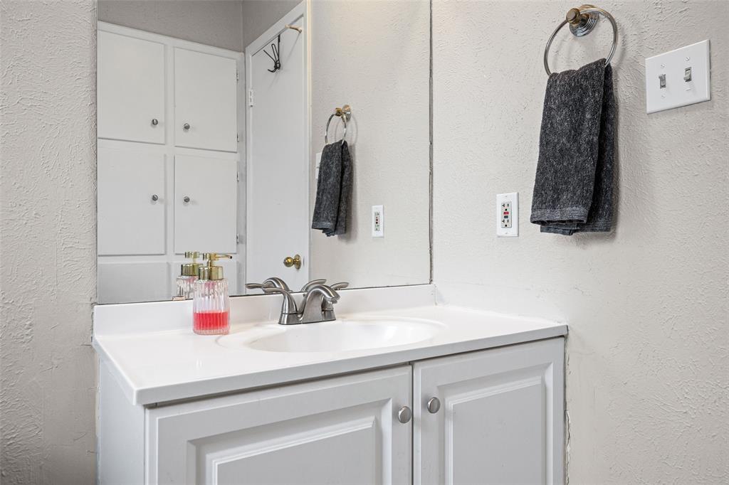 3900 Cresthill Road Benbrook, TX 76116 - Photo 14 of 18 a bathroom with a sink vanity and a mirror