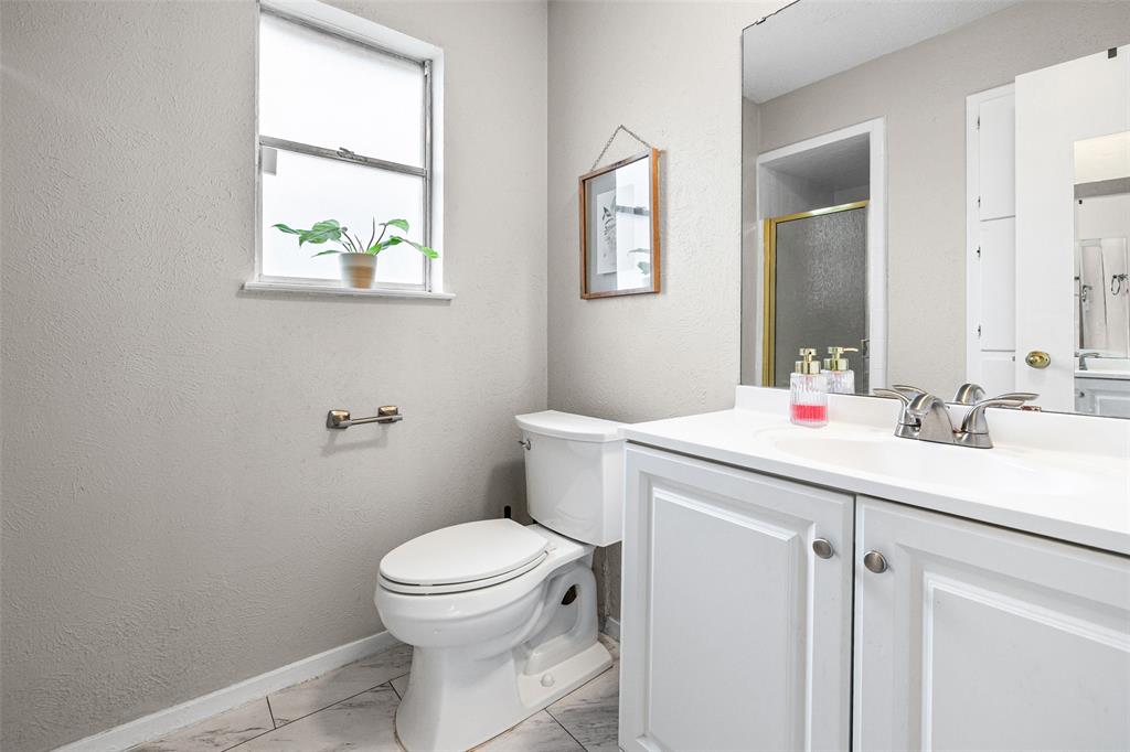 3900 Cresthill Road Benbrook, TX 76116 - Photo 15 of 18 Bathroom featuring vanity, a stall shower, and light marble finish flooring