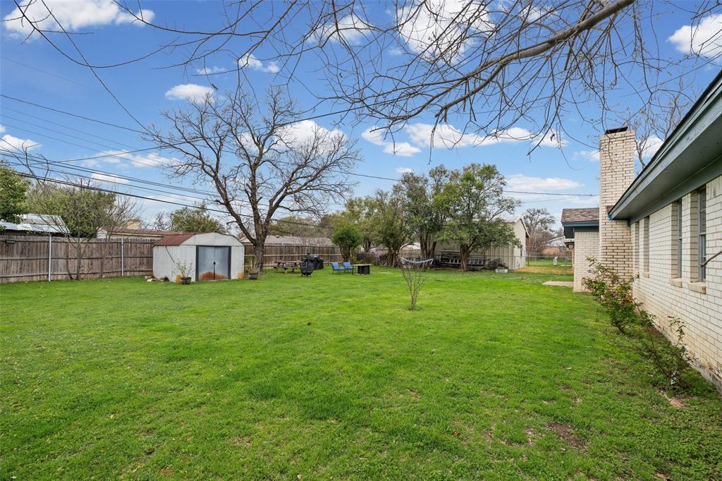 3900 Cresthill Road Benbrook, TX 76116 - Photo 17 of 18 Fenced backyard with a storage unit
