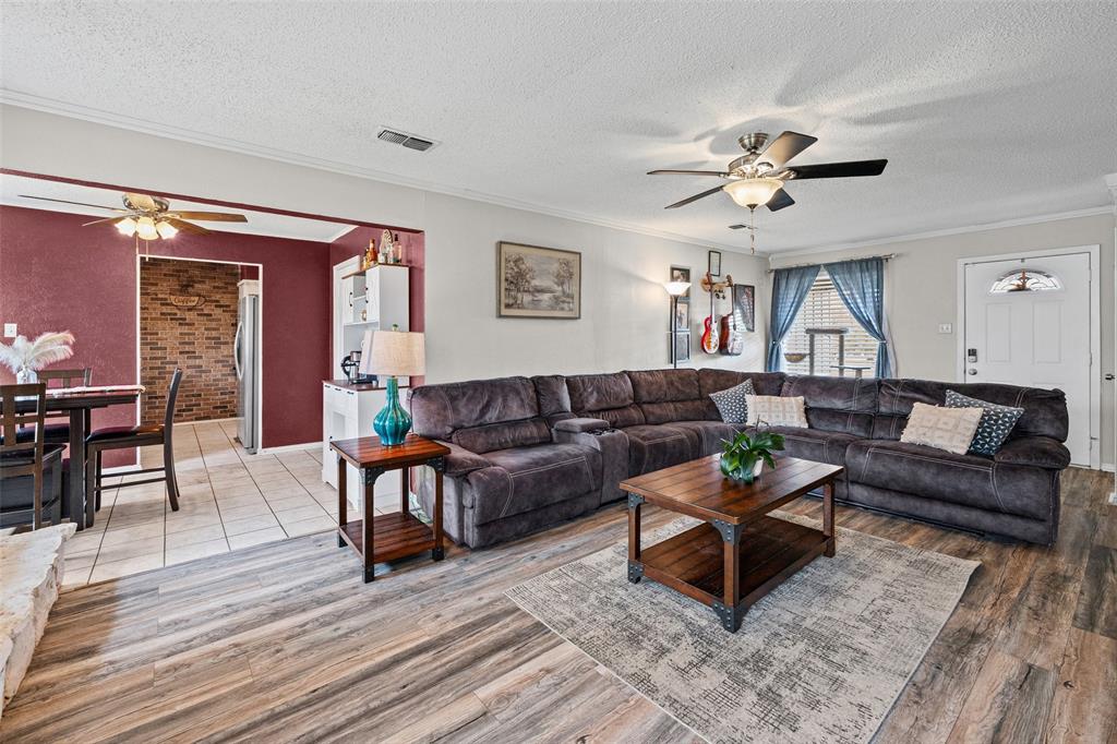 3900 Cresthill Road Benbrook, TX 76116 - Photo 3 of 18 a living room with furniture and a wooden floor