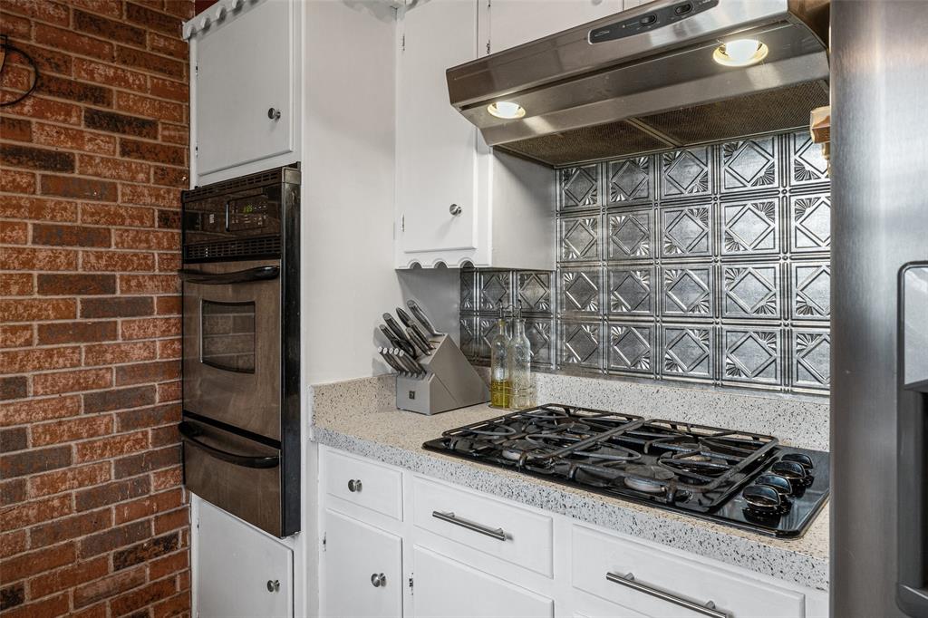 3900 Cresthill Road Benbrook, TX 76116 - Photo 4 of 18 a kitchen with a stove and a refrigerator