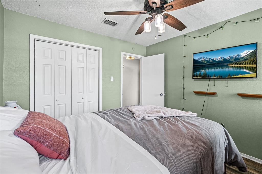 3900 Cresthill Road Benbrook, TX 76116 - Photo 7 of 18 a bedroom with a bed and a flat screen tv