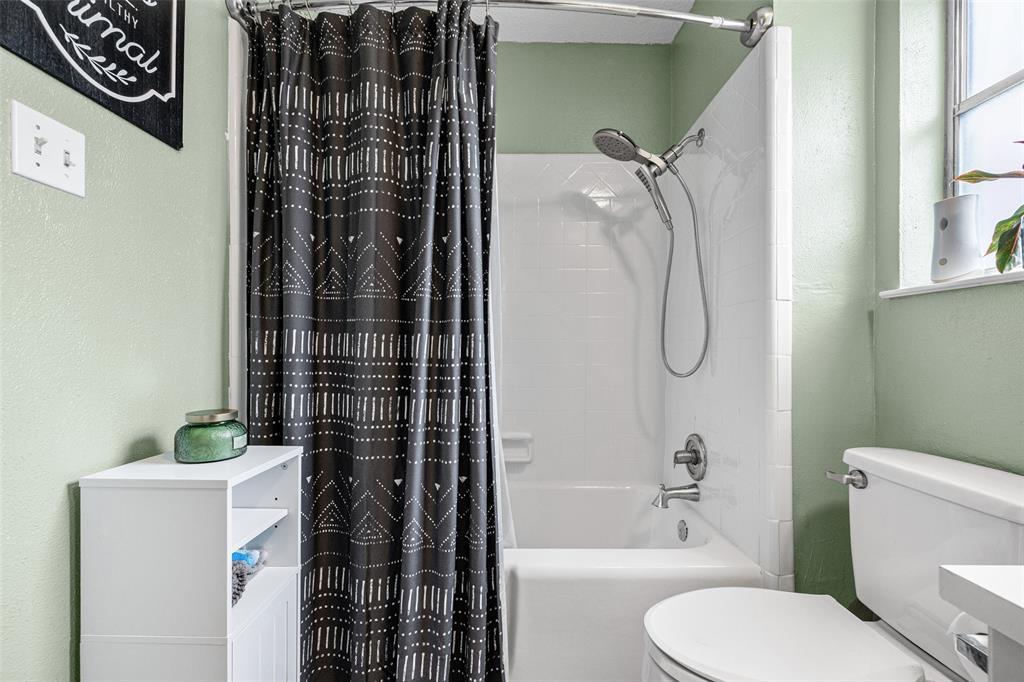 3900 Cresthill Road Benbrook, TX 76116 - Photo 8 of 18 a bathroom with a shower a toilet and a shower