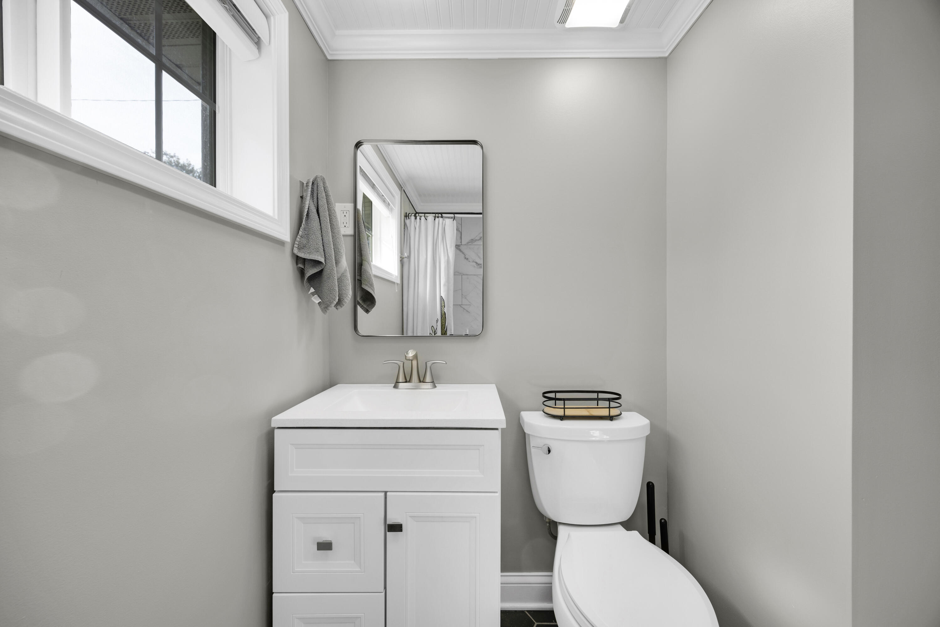 549 Ridgelawn Street Crown Point, IN 46307 - Photo 10 of 18 a bathroom with a toilet a sink and mirror