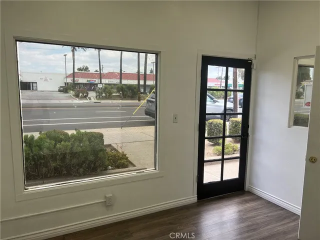 an empty room with wooden floor and a window
