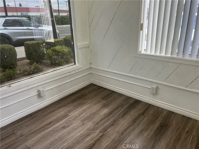 a view of a closet area with wooden floor