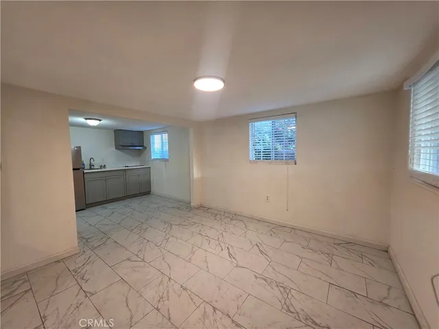 an empty room with a bathroom and a sink