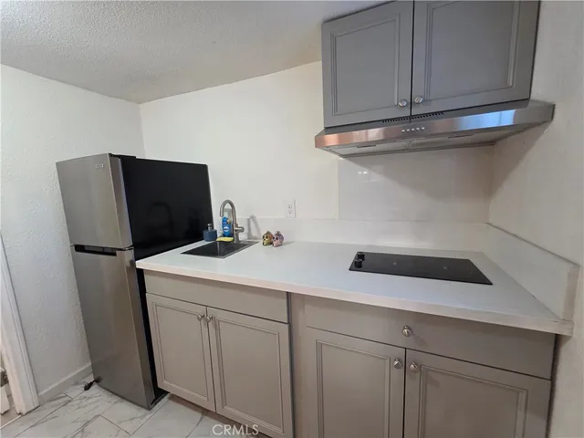 a kitchen with a refrigerator and cabinets