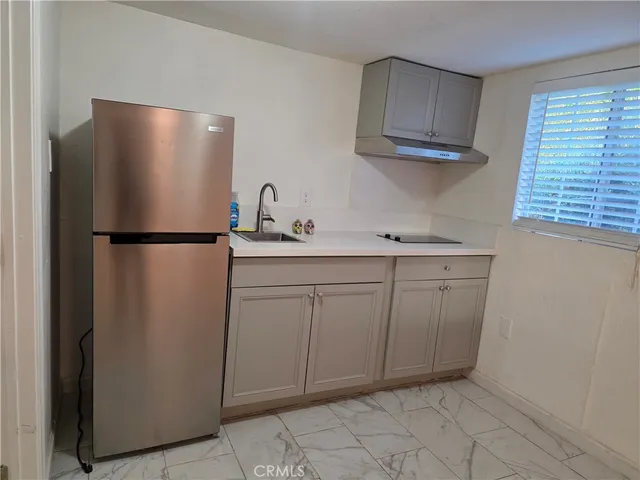 a kitchen with a refrigerator and cabinets