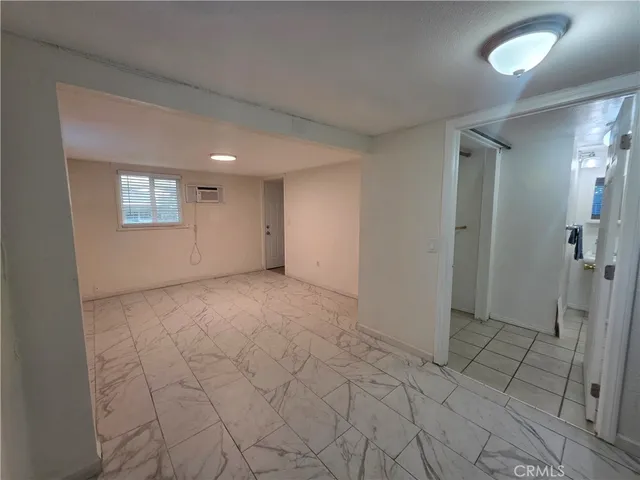 a view of an empty room and a window