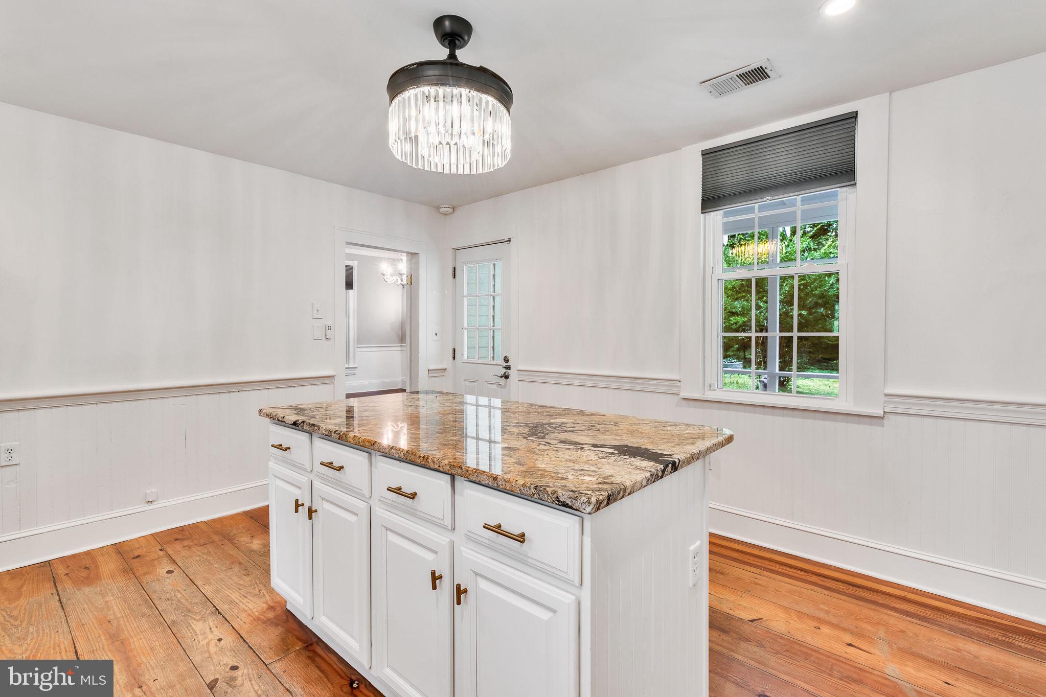 3952 Irvington Road Irvington, VA 22480 - Photo 17 of 77 a kitchen with stainless steel appliances granite countertop a sink and a window