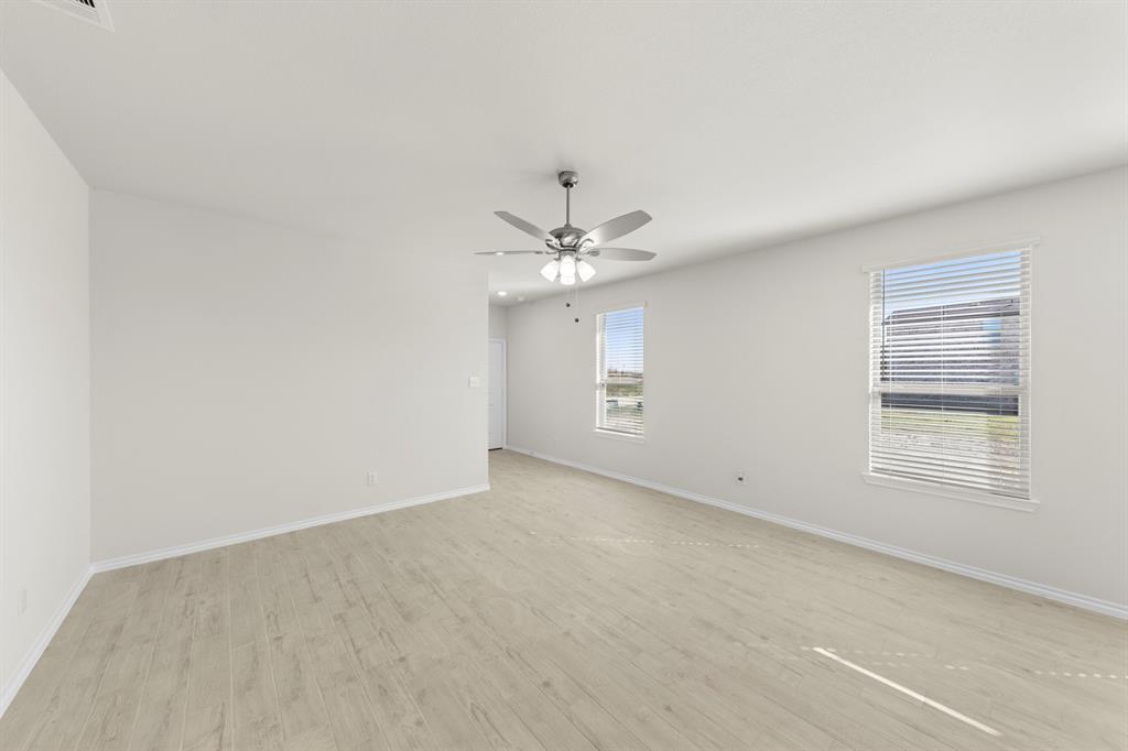 125 Pheasant Run Road Terrell, TX 75160 - Photo 11 of 27 an empty room with windows and fan