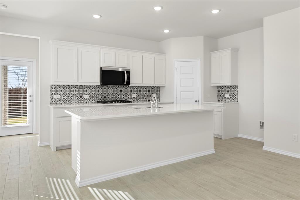 125 Pheasant Run Road Terrell, TX 75160 - Photo 6 of 27 a kitchen with stainless steel appliances granite countertop a sink and a stove top oven