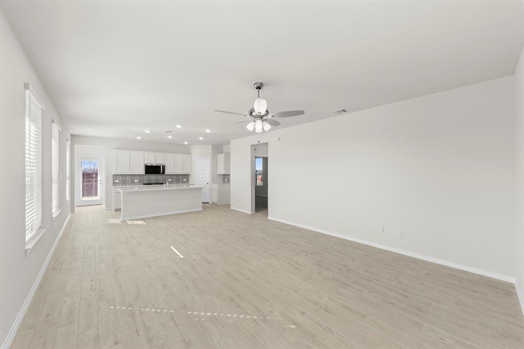 125 Pheasant Run Road Terrell, TX 75160 - Photo 9 of 27 a view of a livingroom with kitchen view and a chandelier