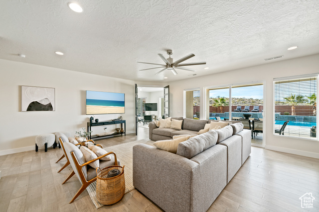 6026 Zen Trail Way St. George, UT 84790 - Photo 18 of 41 Living area with a ceiling fan, recessed lighting, light wood-style flooring, and a textured ceiling