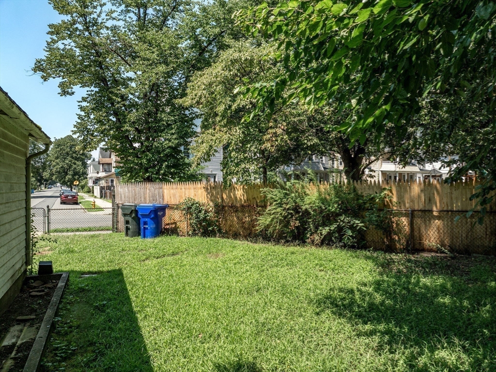 55 Pasadena Street Springfield, MA 01108 - Photo 17 of 33 a view of a backyard with large trees