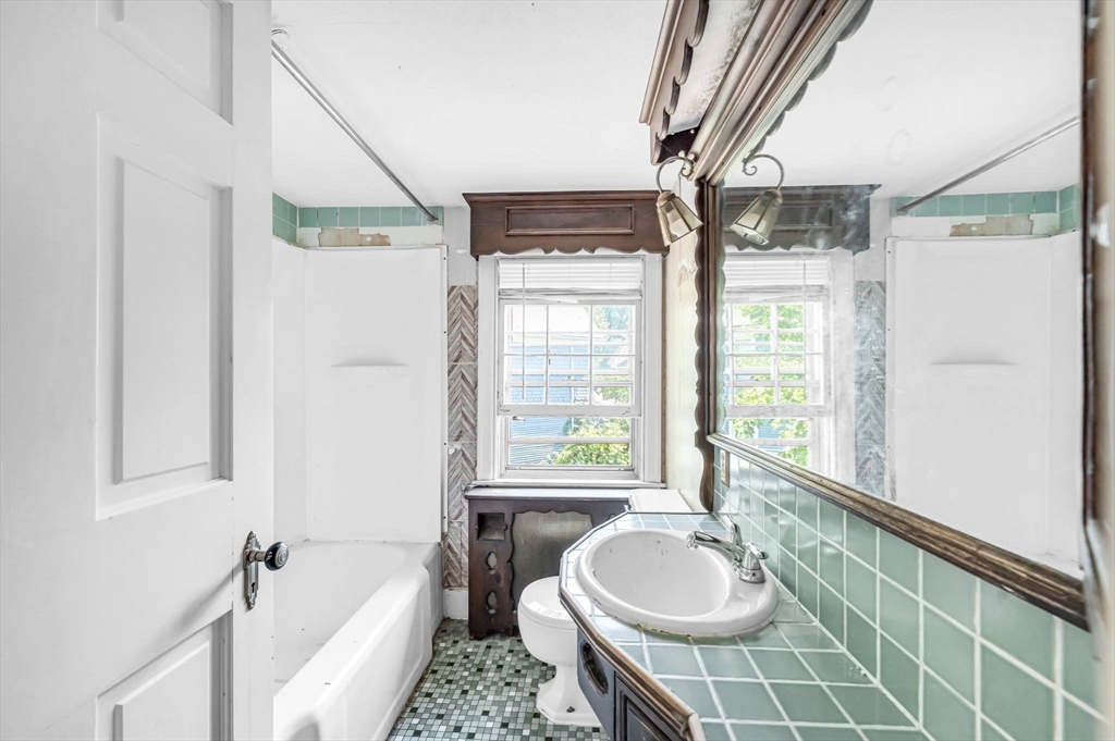 55 Pasadena Street Springfield, MA 01108 - Photo 23 of 33 a spacious bathroom with a tub sink and mirror