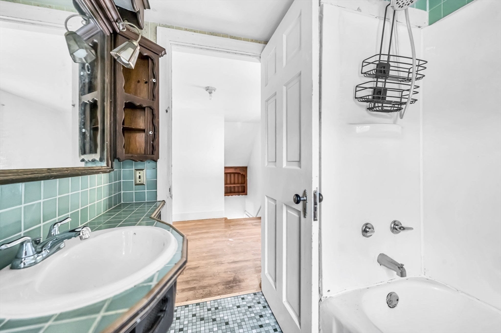 55 Pasadena Street Springfield, MA 01108 - Photo 24 of 33 a bathroom with a tub a sink and a mirror