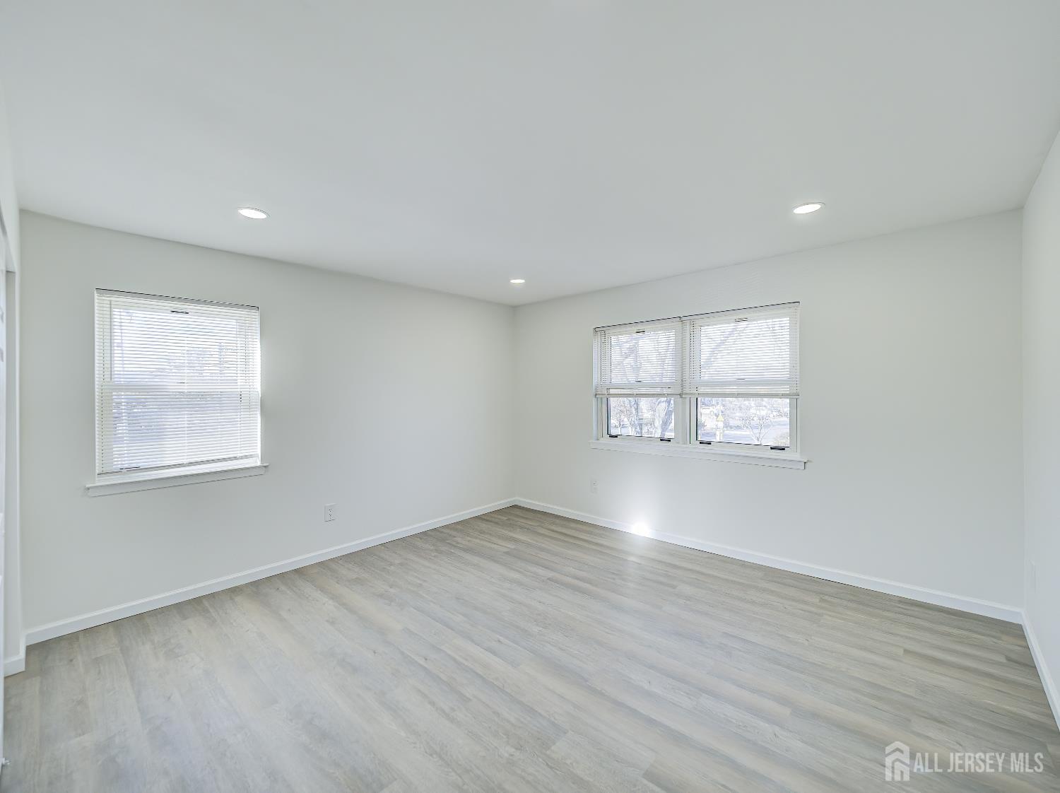18 Judson Street, Unit 22B Edison, NJ 08837 - Photo 16 of 34 an empty room with wooden floor and windows