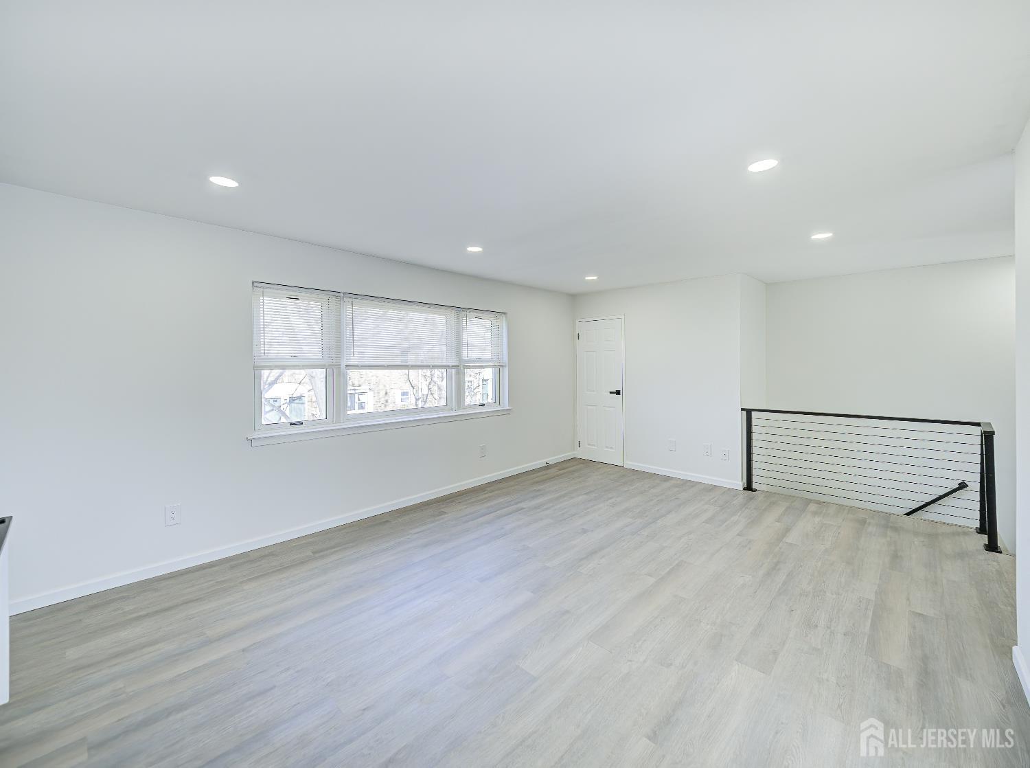 18 Judson Street, Unit 22B Edison, NJ 08837 - Photo 6 of 34 an empty room with wooden floor and windows