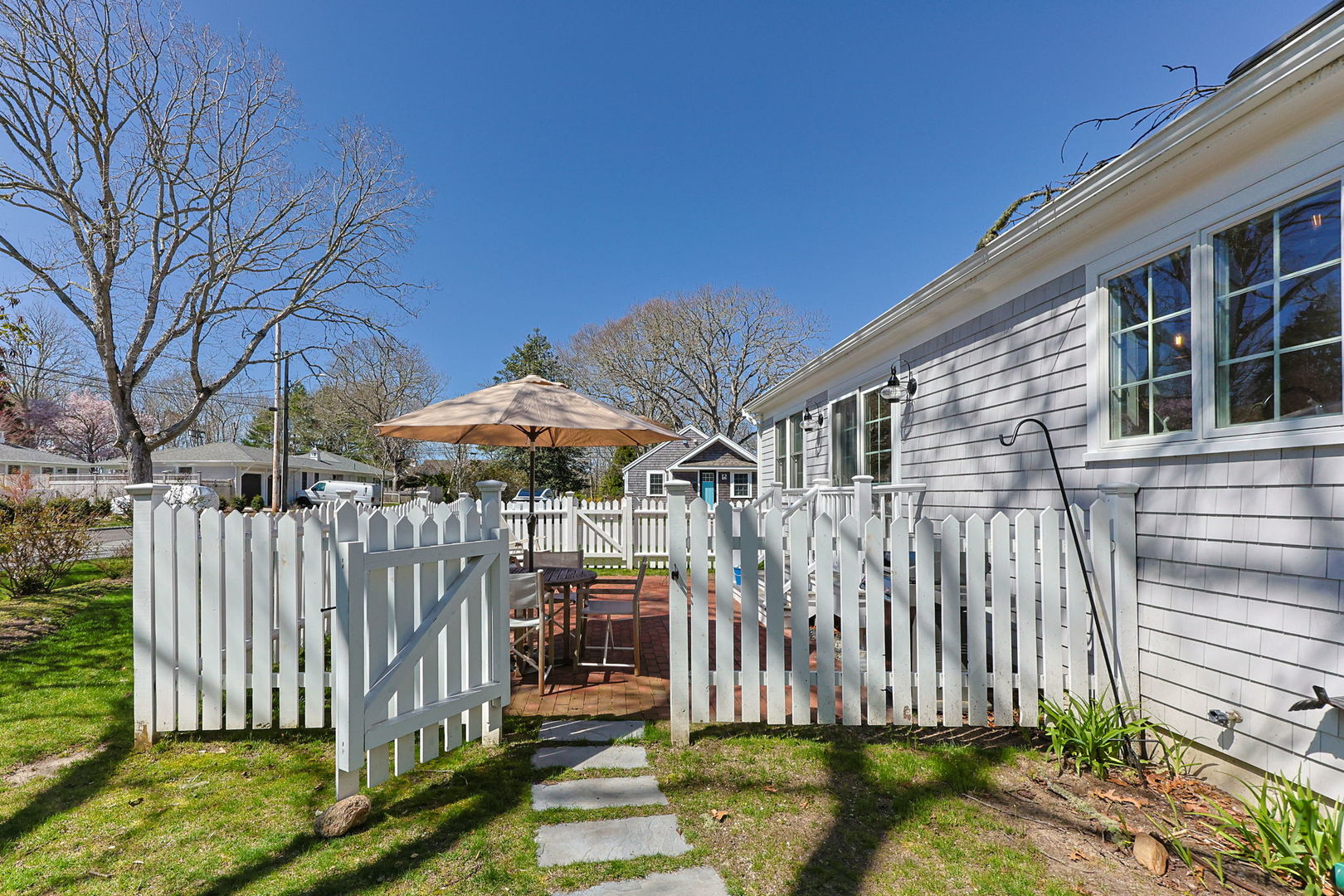 16 2nd Avenue Osterville, MA 02655 - Photo 33 of 49 a view of a house with a small yard and wooden fence