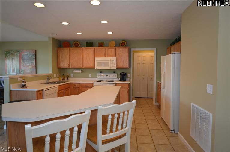 218 Sandstone Ridge Way Berea, OH 44017 - Photo 6 of 25 Wonderful extended island allows for more storage and counter space and it provides breakfast bar eating.