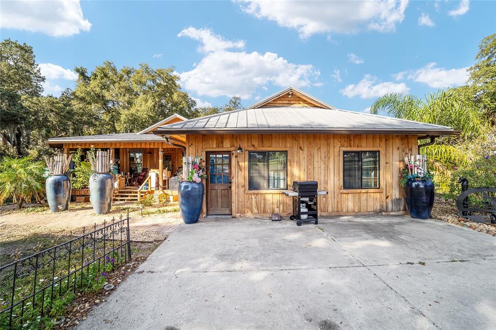 36203 Micro Racetrack Road Fruitland Park, FL 34731 - Photo 2 of 72 a view of a house with sitting area and garden
