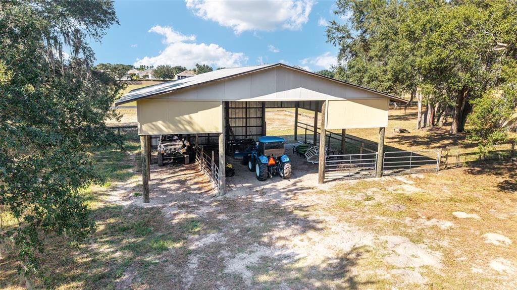 36203 Micro Racetrack Road Fruitland Park, FL 34731 - Photo 21 of 72 a view of a house with backyard porch and sitting area