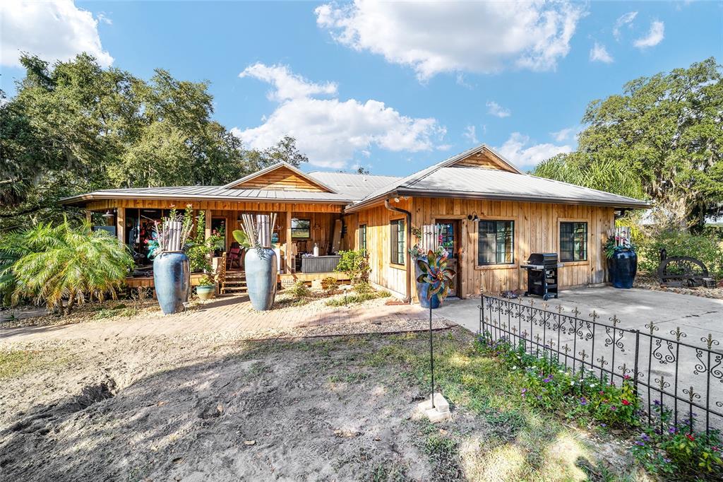 36203 Micro Racetrack Road Fruitland Park, FL 34731 - Photo 26 of 72 a patio with a table and chairs under an umbrella