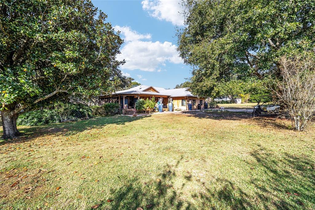36203 Micro Racetrack Road Fruitland Park, FL 34731 - Photo 27 of 72 a front view of a house with a yard