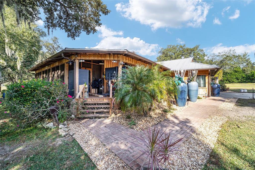 36203 Micro Racetrack Road Fruitland Park, FL 34731 - Photo 29 of 72 a front view of a house with garden