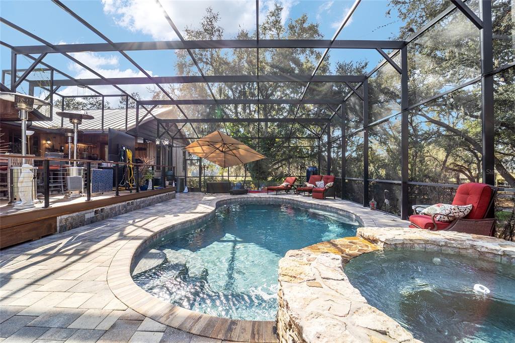 36203 Micro Racetrack Road Fruitland Park, FL 34731 - Photo 59 of 72 a view of a swimming pool with a patio