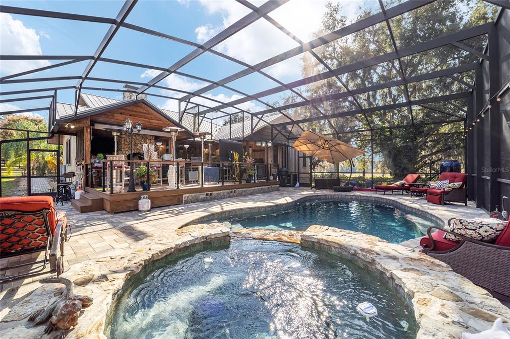 36203 Micro Racetrack Road Fruitland Park, FL 34731 - Photo 60 of 72 a view of a swimming pool with sitting area