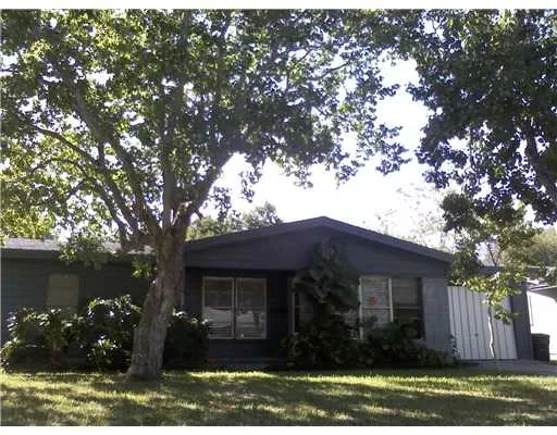 a view of house with yard and a garden
