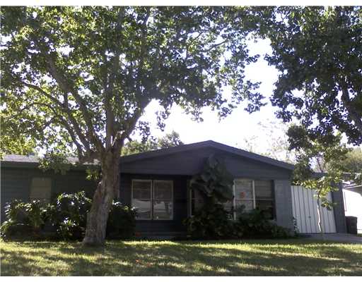 a view of house with yard and a garden